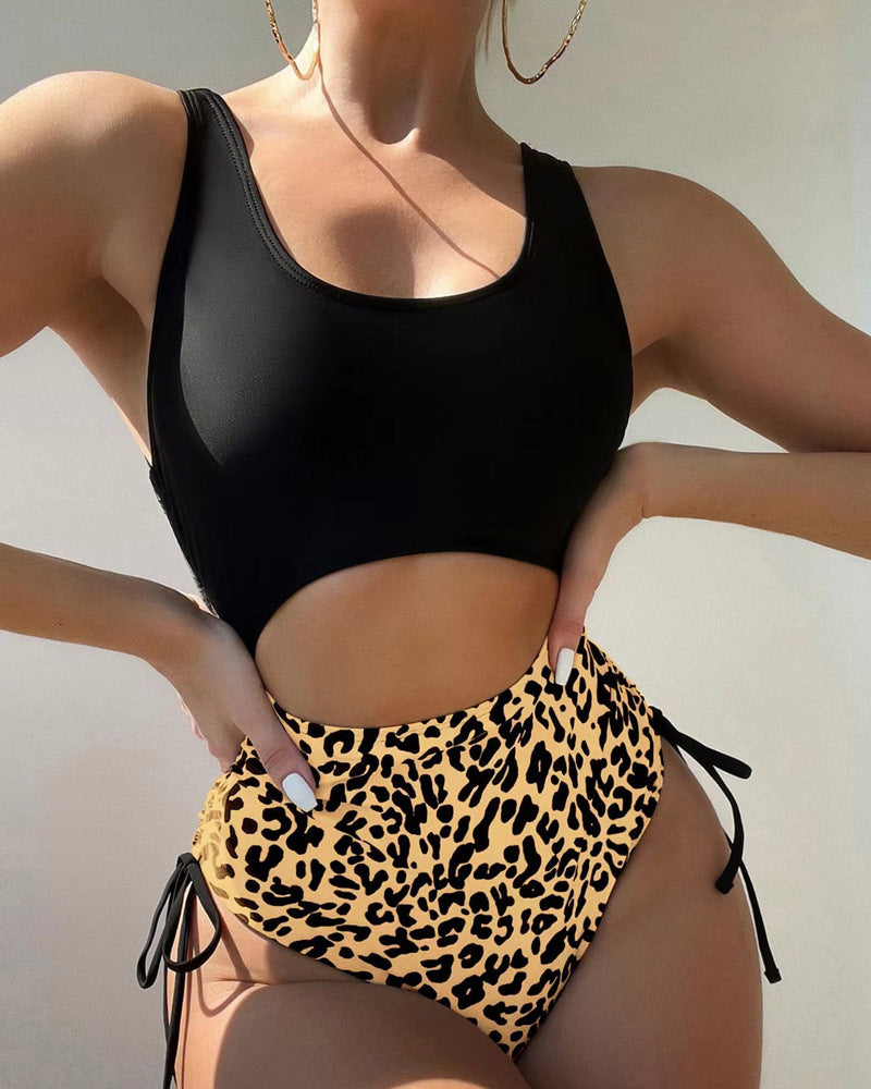 bikini set with black top and gold leopard print bottoms. Bottoms have tie detail
