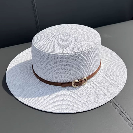 white straw hat with brown strap and gold buckle
